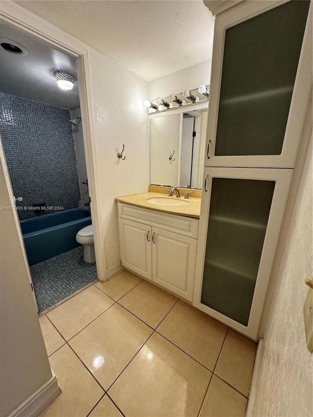 full bathroom with vanity, bathing tub / shower combination, toilet, and tile patterned flooring