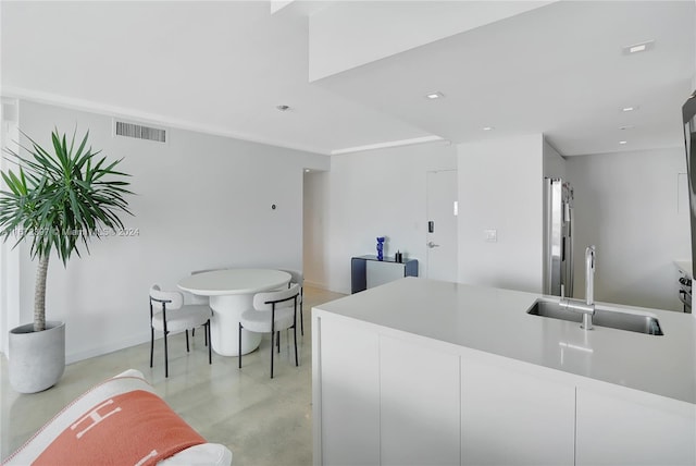 kitchen with white cabinetry and sink