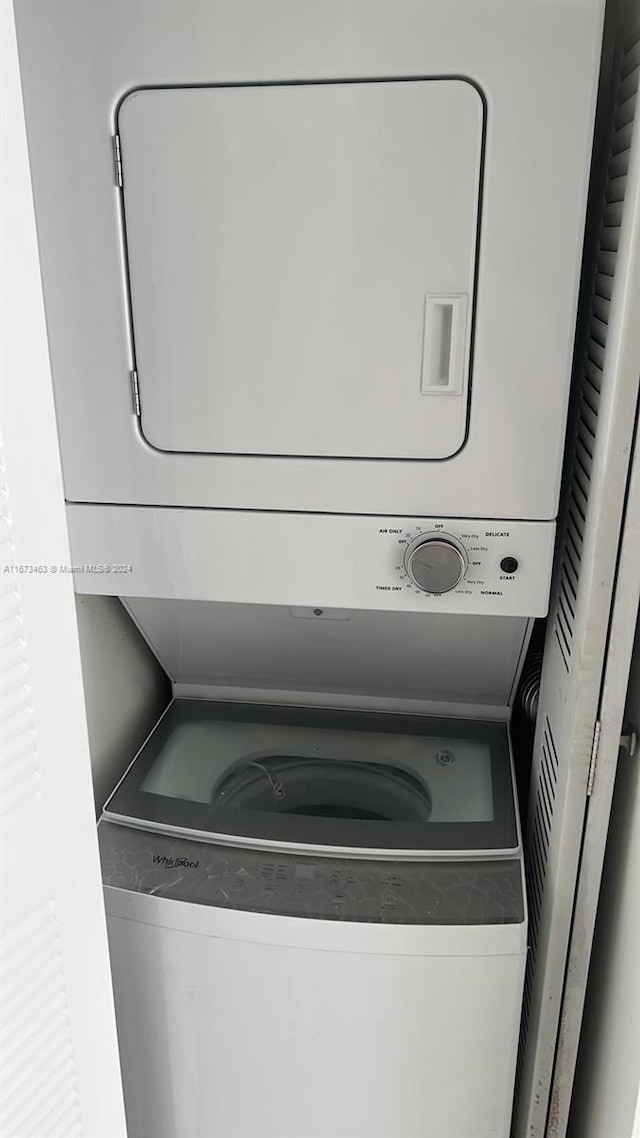 laundry area with stacked washer and dryer