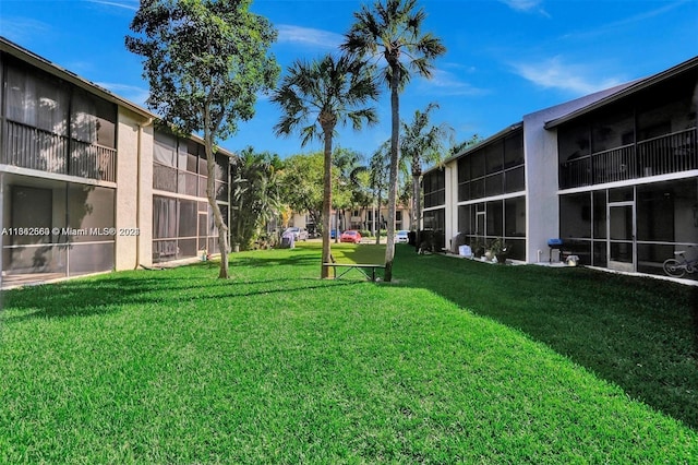 view of yard with a sunroom