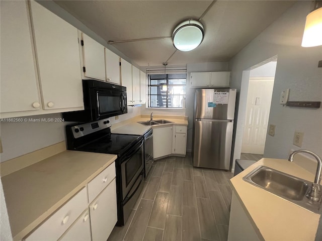 kitchen with white cabinets, black appliances, and sink