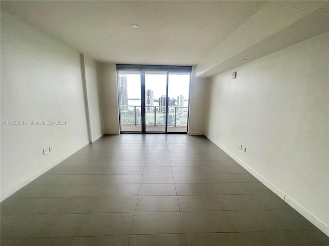 1600 NE 1st Ave Unit 2502, Miami, FL 33132 - spare room with baseboards and dark tile patterned flooring