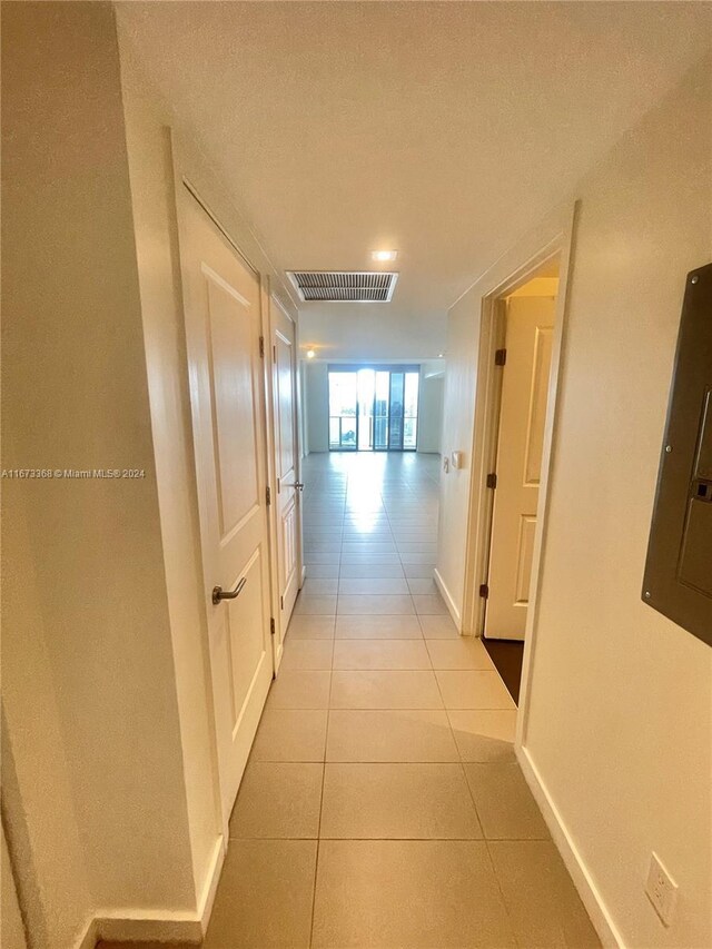 1600 NE 1st Ave Unit 2502, Miami, FL 33132 - hallway featuring light tile patterned floors, electric panel, and a textured ceiling