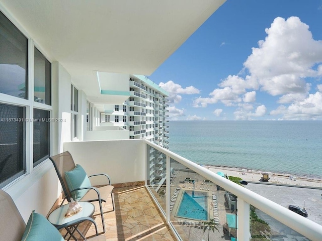 balcony with a beach view and a water view