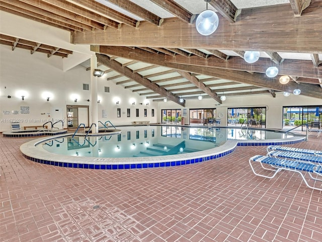 view of swimming pool with an indoor hot tub