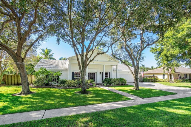 view of front facade with a garage and a front lawn