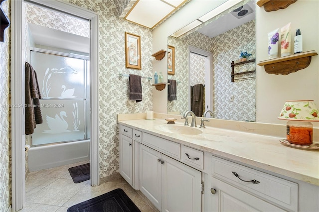 bathroom featuring tile patterned flooring, vanity, and wallpapered walls