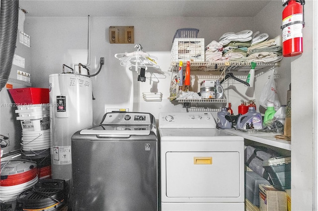 laundry area with washing machine and dryer, laundry area, and water heater