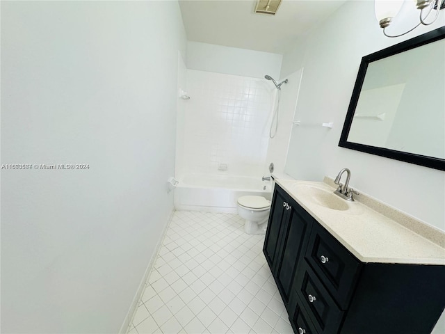 full bathroom with tile patterned flooring, tiled shower / bath combo, vanity, and toilet