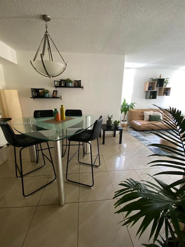 tiled dining room with a textured ceiling