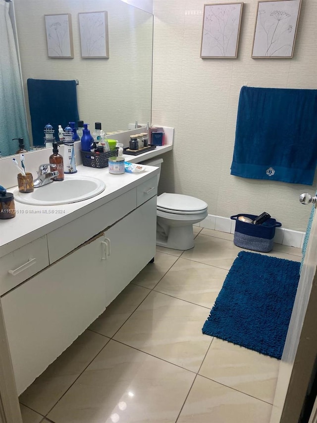 bathroom featuring vanity, tile patterned flooring, and toilet