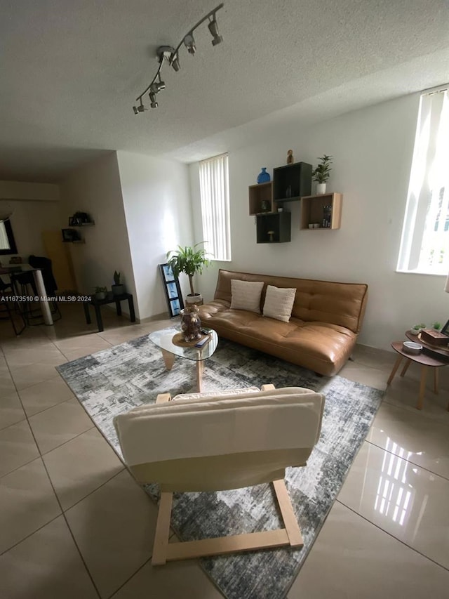 tiled living room featuring a textured ceiling