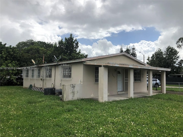 back of house featuring a yard and a patio