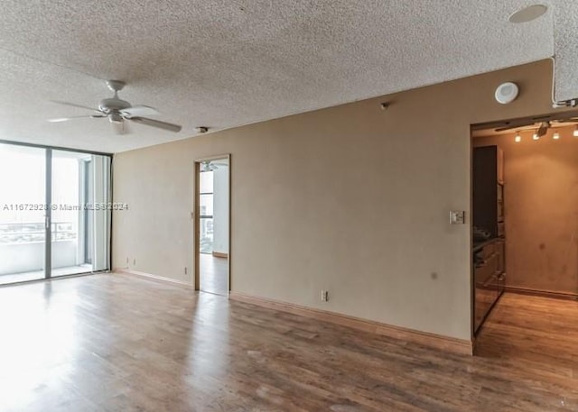 spare room with wood-type flooring, a textured ceiling, and ceiling fan