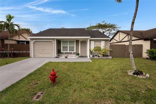 ranch-style home featuring a garage and a front lawn