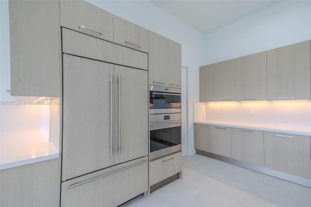 kitchen with paneled built in fridge and double oven