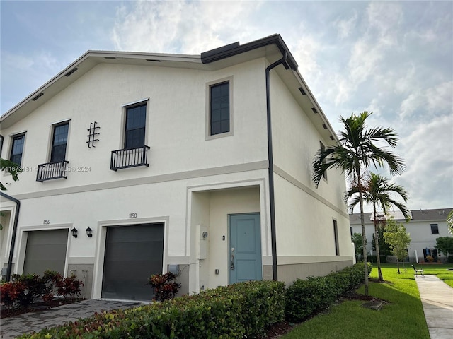 view of front of property with a garage and a front yard