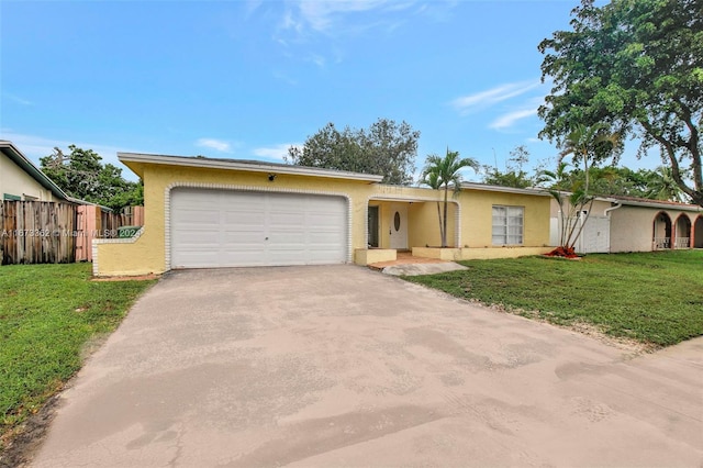 ranch-style home with a garage and a front lawn