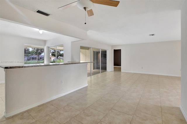 tiled empty room with ceiling fan