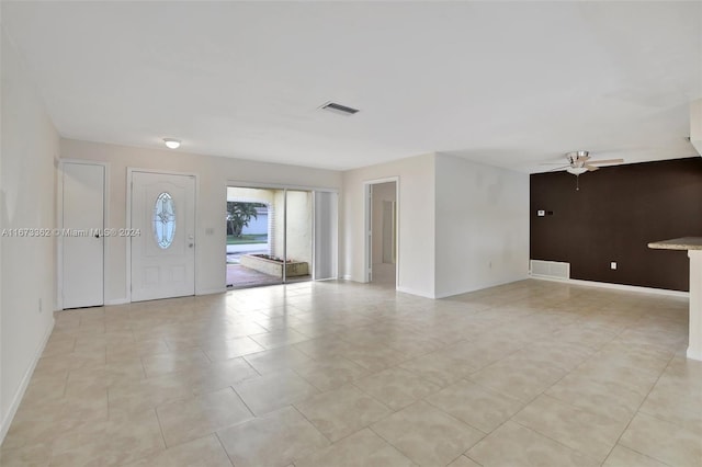 tiled foyer entrance with ceiling fan