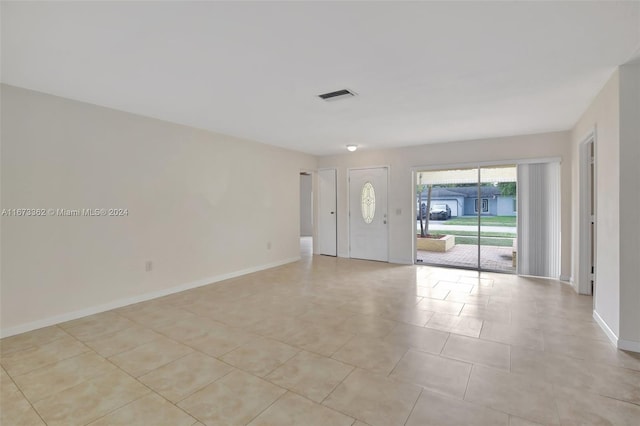 spare room featuring light tile patterned flooring