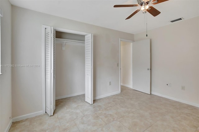 unfurnished bedroom featuring light tile patterned flooring, ceiling fan, and a closet