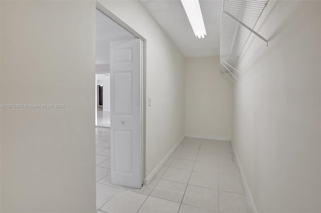 spacious closet with light tile patterned floors