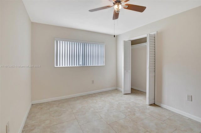 unfurnished bedroom featuring a closet, ceiling fan, and light tile patterned flooring