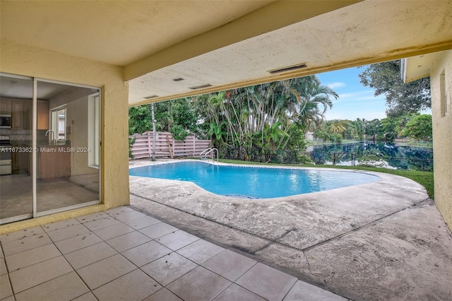 view of swimming pool with a patio and sink