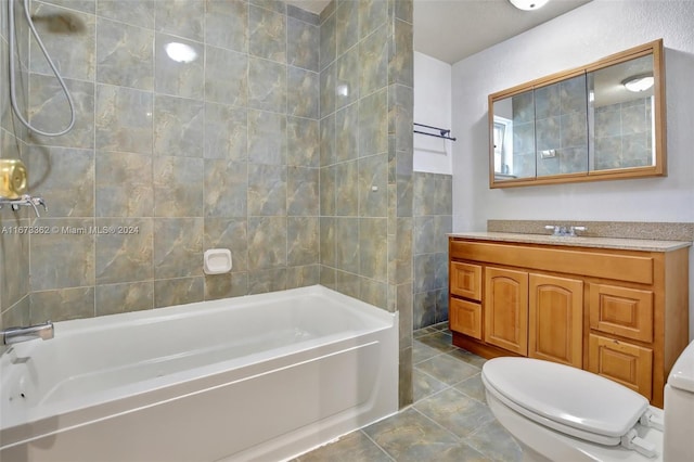 full bathroom with tile patterned flooring, tiled shower / bath combo, vanity, and toilet