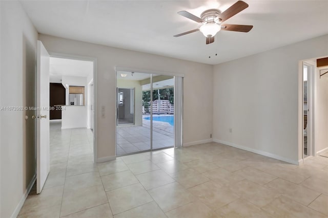 tiled empty room featuring ceiling fan