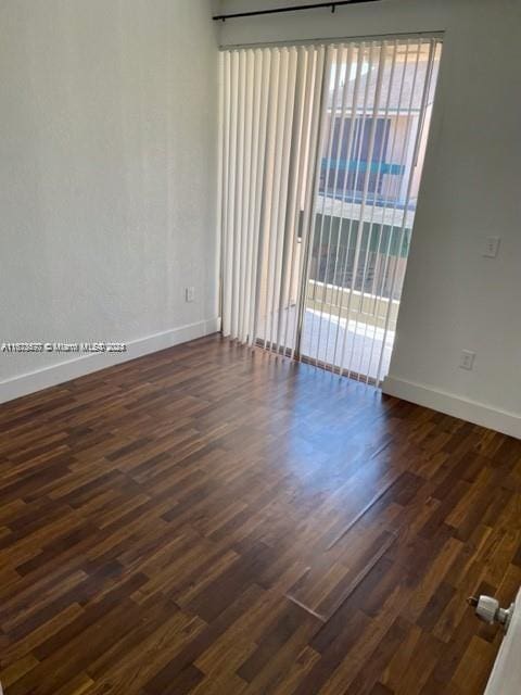 9173 Fontainebleau Blvd Unit 3, Miami, FL 33172 - unfurnished room with baseboards and dark wood-type flooring