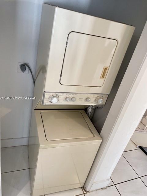9173 Fontainebleau Blvd Unit 3, Miami, FL 33172 - laundry area with estacked washer and dryer and light tile patterned flooring