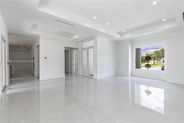 spare room featuring a raised ceiling