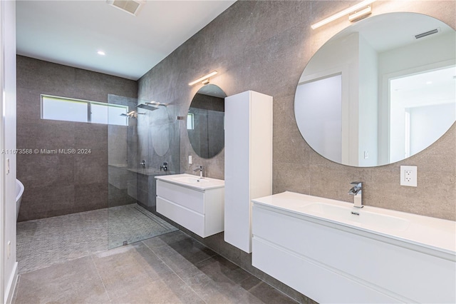 bathroom featuring tile patterned floors, vanity, and tiled shower