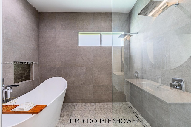 bathroom featuring tile patterned floors, shower with separate bathtub, and sink