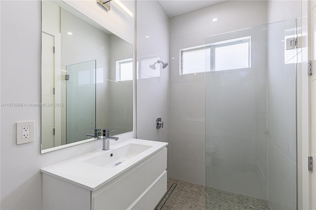 bathroom with walk in shower and vanity