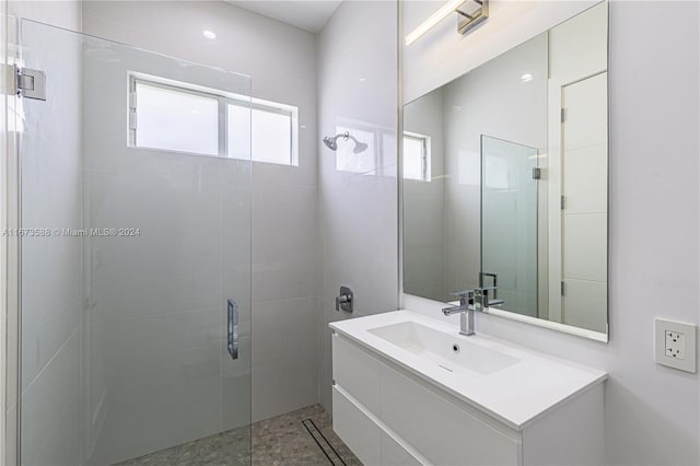 bathroom with walk in shower and vanity