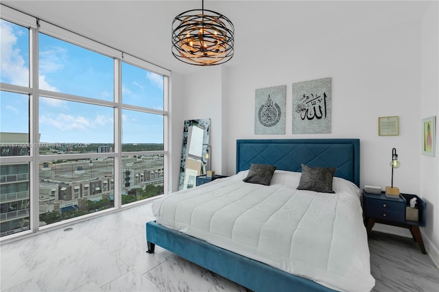 bedroom with floor to ceiling windows and a chandelier