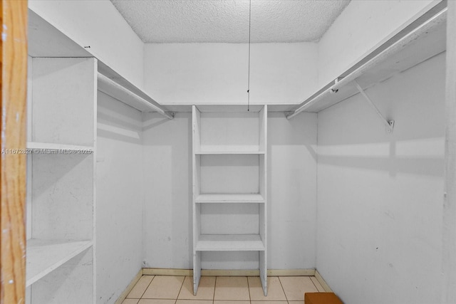 spacious closet featuring light tile patterned flooring