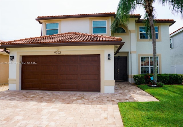 mediterranean / spanish-style house featuring a front yard