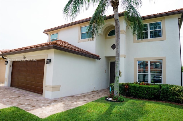 mediterranean / spanish home featuring a garage