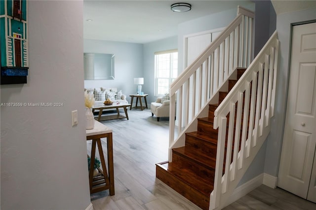 staircase with wood-type flooring