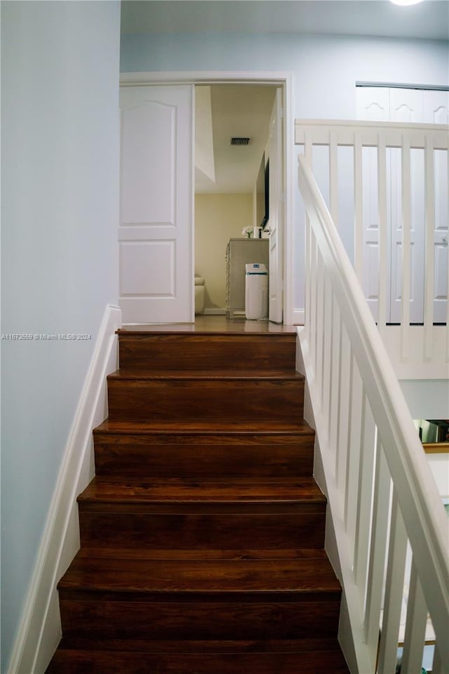 stairs with wood-type flooring