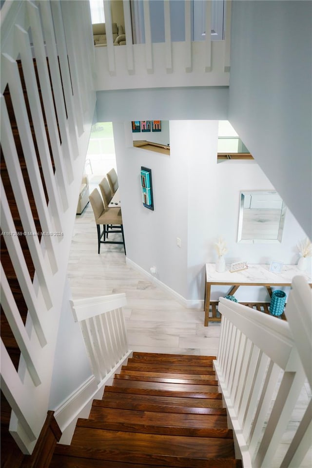 stairs featuring hardwood / wood-style floors