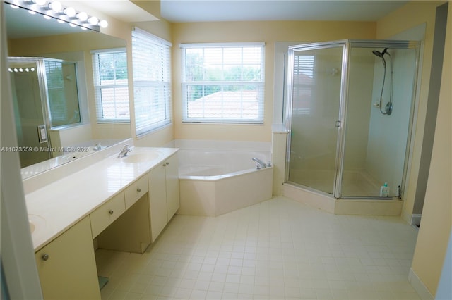 bathroom featuring tile patterned flooring, vanity, and independent shower and bath