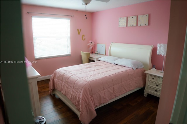 bedroom with dark hardwood / wood-style flooring and ceiling fan