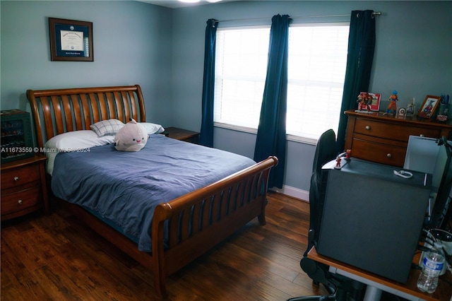 bedroom with dark hardwood / wood-style flooring