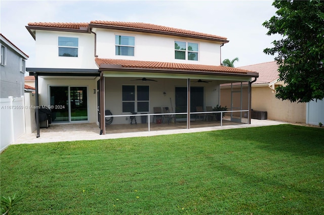 rear view of house featuring a patio, a sunroom, a lawn, and ceiling fan