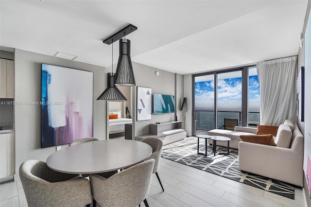 dining area featuring light hardwood / wood-style floors and floor to ceiling windows